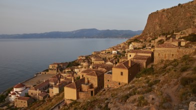 Soft morning light, medieval coastal town at sunrise with sea view and tiled roofs, Monemvasia,