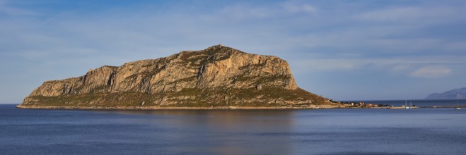 Massive rocky island juts out of the still sea in the afternoon, Monemvasia, Monemvassia, Malvasy,