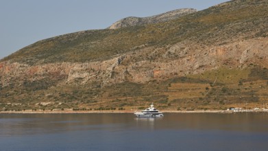 Yacht on calm water in front of a landscape with rocky mountains, Monemvasia, Monemvassia, Malvasy,