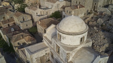 Drone view, historic church with dome surrounded by a village, taken from the air, Monemvasia,