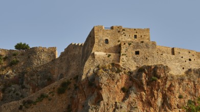 Stone fortress on rocky hill with reddish rock, Monemvasia, Monemvassia, Malvasy, small Byzantine