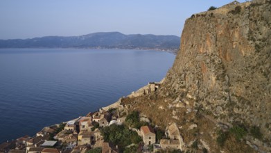 Drone shot, coastal landscape with cliffs, traditional village and mountain view, Monemvasia,