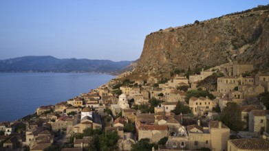 Drone shot, steep cliff with traditional village architecture and sea view, Monemvasia,