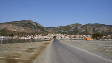 Paved road leads to a seaside town with mountains in the background, Monemvasia, Monemvassia,