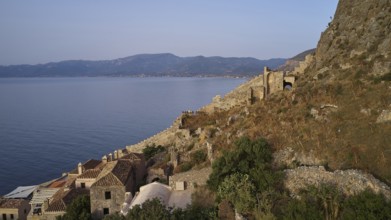Drone shot, coastal landscape with medieval ruins and view of the blue sea, Monemvasia,
