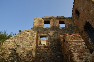 Soft morning light, the remains of an old stone building, window openings, blue sky, dilapidated,