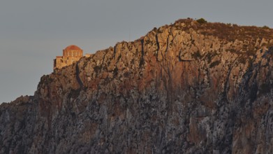 Orhodox church of Hagia Sophia, chapel on bright rock wall in evening light with scenic backdrop,
