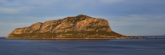 Rocky island in calm water at sunset with blue sky, Monemvasia, Monemvassia, Malvasy, Byzantine