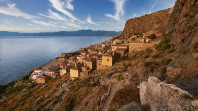 Sky replaced, traditional coastal village with stone houses on a steep rocky coast, Monemvasia,