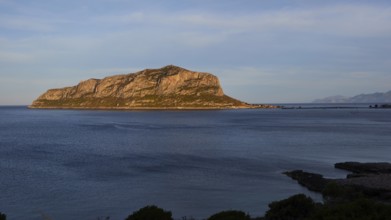 Flat rocky island in the calm blue sea under a clear sky, Monemvasia, Monemvassia, Malvasy,