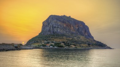 HDR, impressive seaside rock in warm sunrise light, calm water surface, Monemvasia, Monemvassia,