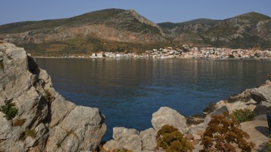 Quiet coastline with mountains in the background and a picturesque village, Monemvasia,