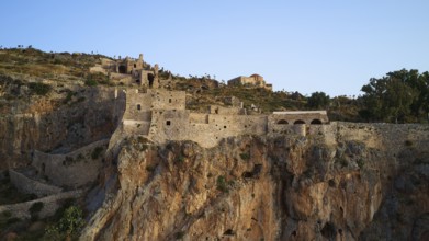 Mighty castle perched over rocky landscape under clear sky, Monemvasia, Monemvassia, Malvasy,