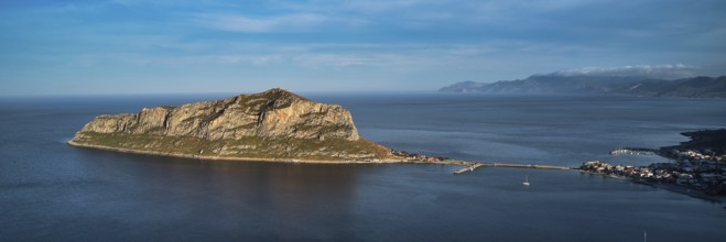 Drone shot, island connected to the mainland by bridge, surrounded by blue water, Monemvasia,