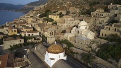 Drone shot, panoramic view of the seaside village with distinctive church dome and ancient