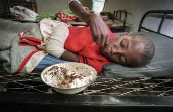 RWA Rwanda Kigali Injured Tutsi refugee children receive medical care in a makeshift hospital by