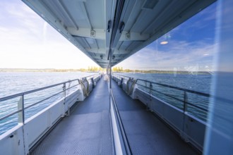 Boat trip with window reflection showing the sea on a sunny day, boat trip, Lake Constance, Germany