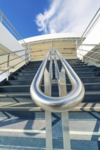 Modern metal staircase on a boat with a view of the blue sky, boat trip, Lake Constance, Germany