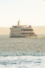 Large ship on calm water with sunny horizon, boat trip, Lake Constance, Germany