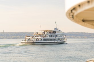 A ship sails away from a shore while part of another ship is visible, Schiff Fahrt, Lake Constance,