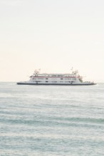 A big bright ship moves on a calm lake with a clear sky, Schiff Fahrt, Lake Constance, Germany
