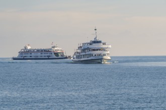 Two large ships sail in the same direction on a calm body of water, Schiff Fahrt, Lake Constance,