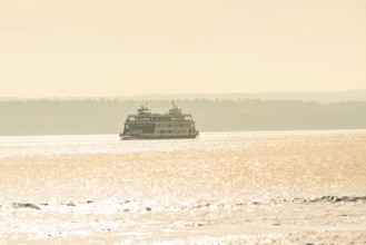 Ship sails across a calm lake in sparkling sunlight, boat trip, Lake Constance, Germany