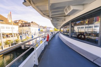 Arrival of the ferry in a lively harbor with a view of the city, boat trip, Lake Constance, Germany