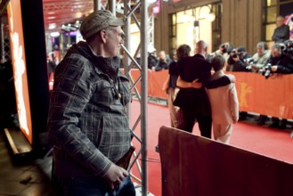DEU, Germany, Berlin Man with beer in hand watches the hustle and bustle on the red carpet in front
