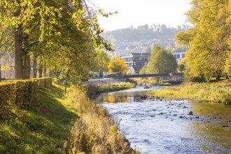 River in an autumn cityscape with bridge, Nagold, Black Forest, Germany