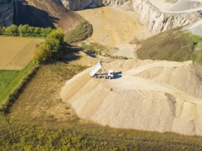 A dump truck seen from the air on a pile of sand near a quarry, Nagold, Black Forest, Germany