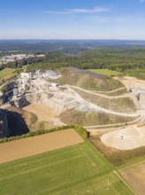 A quarry in a green landscape with forest and cultivated fields, Nagold, Black Forest, Germany