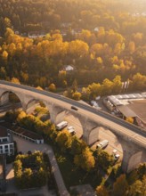 A viaduct crosses an area in autumn colors, with houses and surrounding nature, Nagold, Black