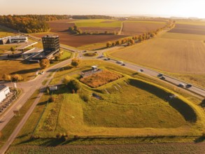 Wide landscape with roads and fields in autumn colors under a golden sky, Nagold, Black Forest,