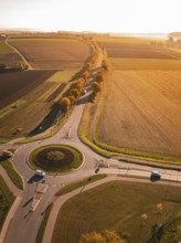 Aerial view of a roundabout surrounded by autumn fields in the evening light, Nagold, Black Forest,