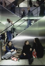Berlin, DEU, 12.09.1999 -- Young visitors to the Potsdamer Platz arcades take a cigarette break.