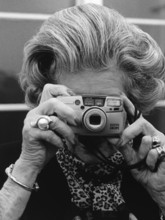 DEU, Germany, Berlin, 22.11.1999. An elderly woman takes pictures during an exhibition opening in
