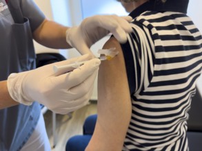 Patient woman receives injection in upper arm for vaccination against contagious disease flu flu