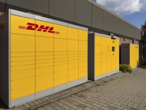 Large DHL packing station in typical yellow color with red logo, Germany