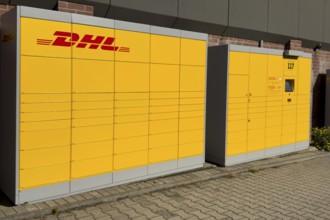 Large DHL packing station in typical yellow color with red logo, Germany