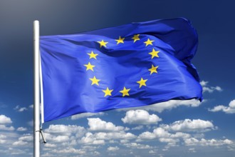 European Union flag waving against blue sky, photo montage