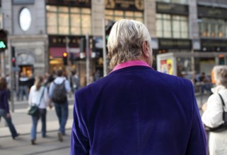DEU Berlin tourist with purple jacket on Rosenthaler Straße in Berlin Mitte Germany Berlin Tourist