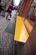 DEU Germany Berlin Orange Bank in front of a shop on a street in Berlin Mitte. Germany Berlin