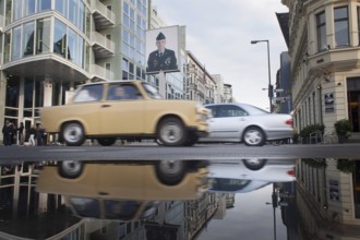 DEU Germany Germany Berlin Trabbi at Checkpoint Charlie with reflection in a puddle after rain
