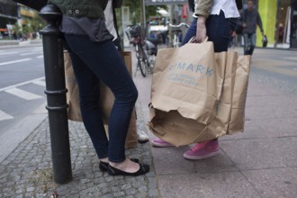 DEU Germany Germany Berlin Young girl with opened Primark shopping bag on Kurfürstendamm in Berlin