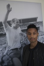 DEU Hamburg British soccer player Michael Mancienne in front of a photo of soccer legend Uwe Seeler