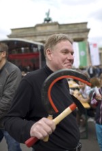 GERMANY A man carries a hammer and sickle in his hand at the DGB rally on May 1. Germany Berlin A