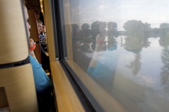 DEU Wittenberge Travelers pass through the flood area around the Luther city Witenberge on the ICE