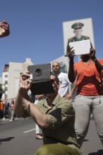 DEU Germany Germany Berlin Tourists take pictures with tablets at Checkpoint Charlie