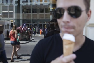 DEU Germany Germany Berlin tourist with ice cream at Checkpoint Charlie